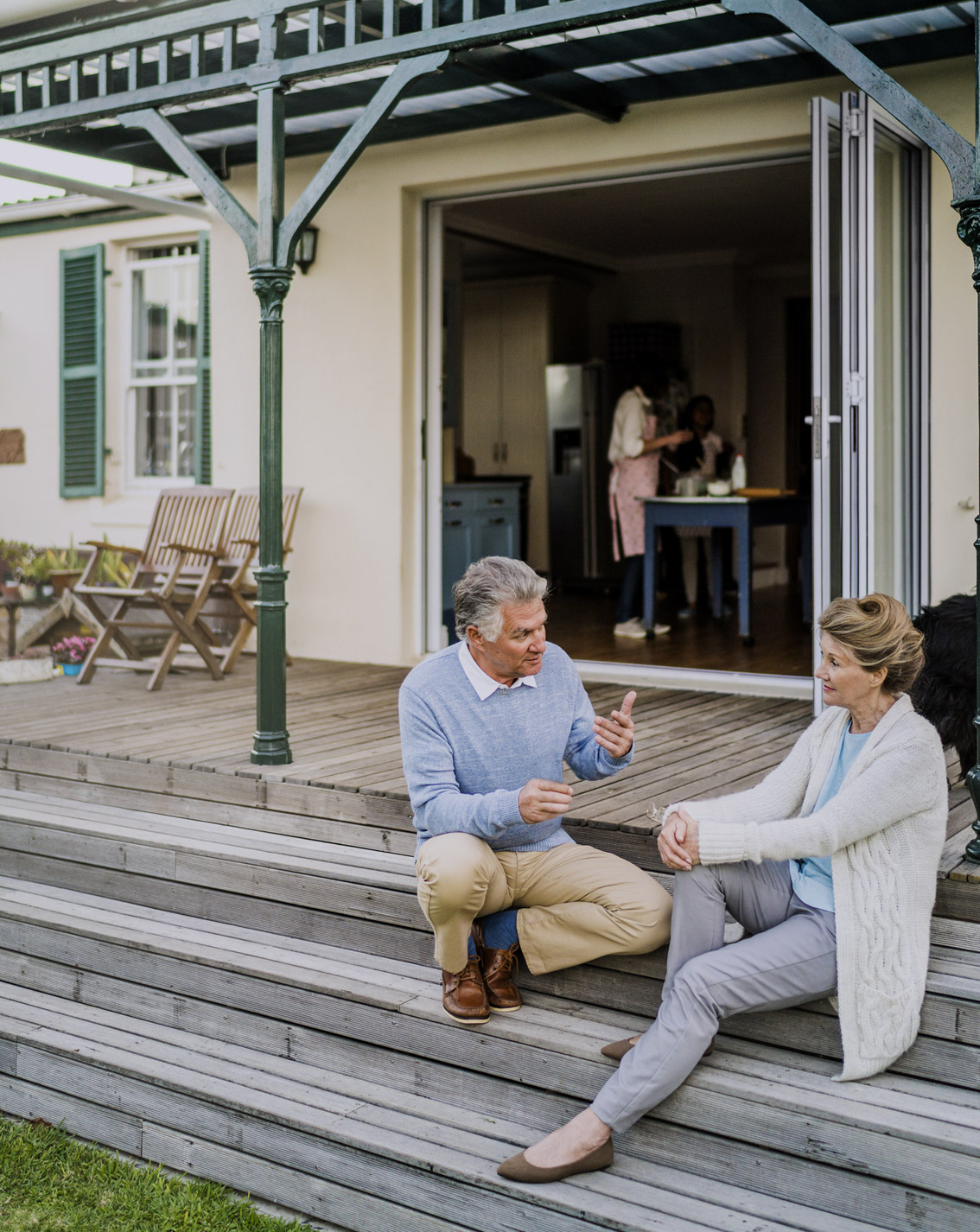 Elderly couple having a conversation in-front of the porch